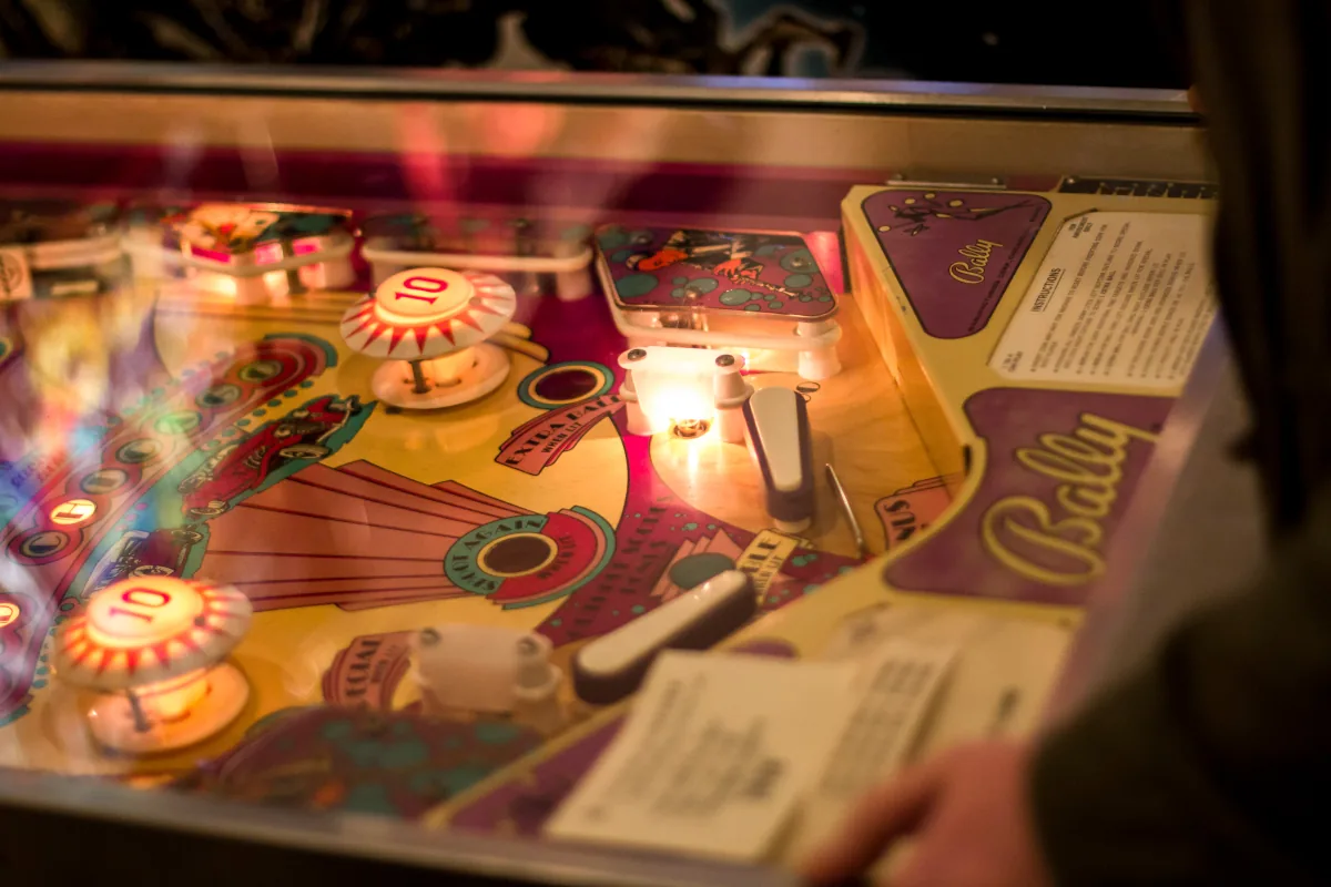 Lit bumpers and hand-painted artwork across a warm Bally playfield.