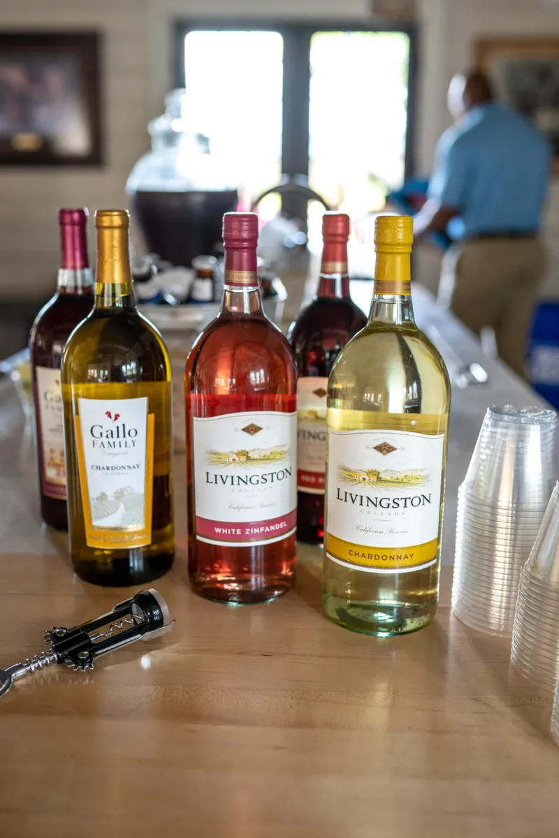 Bottles of wine and glassware set out on a table before an event